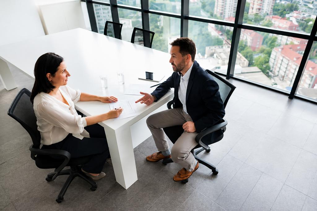 Candidate discussing qualifications with an interviewer during a professional interview, illustrating effective preparation and communication skills for medical interviews.